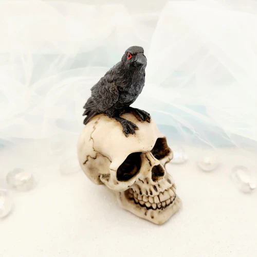 RAVEN SITTING ON SKULL ORNAMENT